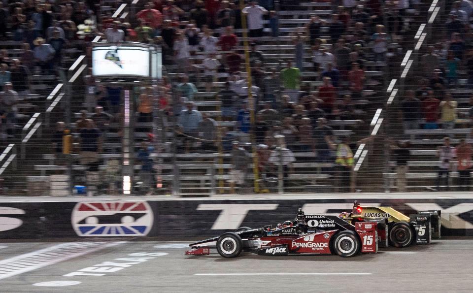 In the closest IndyCar finish in Texas Motor Speedway history, Graham Rahal, front, edges James Hinchcliffe by 0.008 of a second to win the Firestone 600. The race resumed Aug. 27, 76 days after being halted by rain after 71 laps were completed in June.