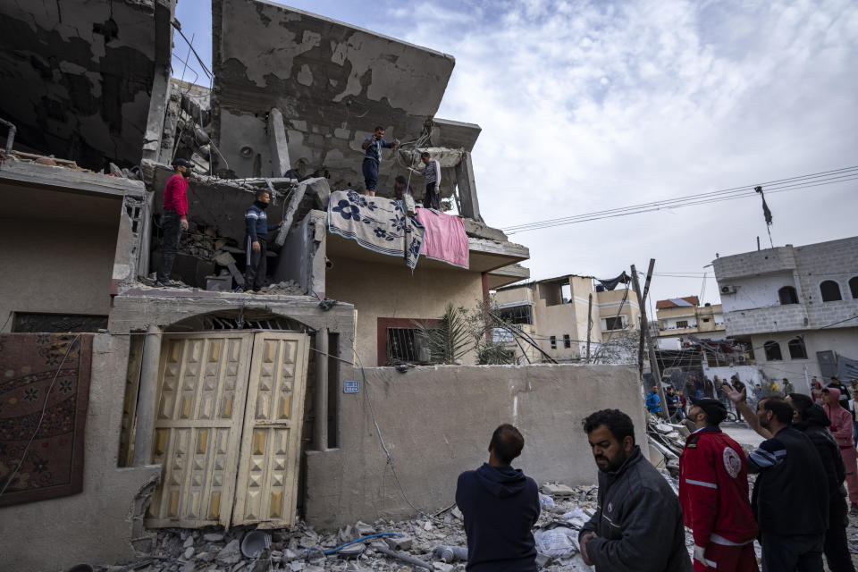 Palestinians search for bodies at a house hit by an Israeli strike in Rafah, Gaza Strip on Wednesday, March 27, 2024. (AP Photo/Fatima Shbair)