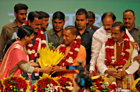 FILE PHOTO: India's ruling Bharatiya Janata Party (BJP) leader Yogi Adityanath (C) is greeted after he was elected as Chief Minister of India's most populous state of Uttar Pradesh, during the party lawmakers' meeting in Lucknow, India March 18, 2017. REUTERS/Pawan Kumar /File photo