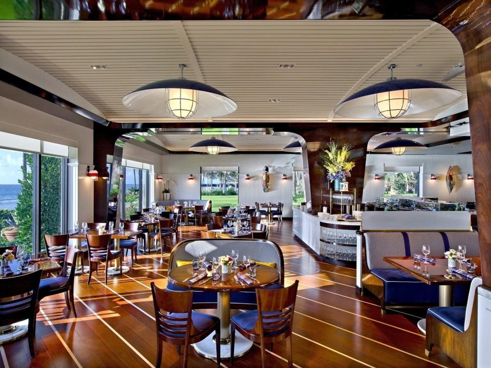 At the oceanfront Seafood Bar at The Breakers, guests are served their meals and drinks on top of a tropical fish-filled aquarium bar top.