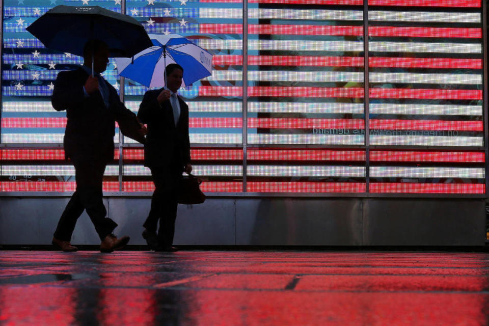 <p>Men walk with umbrellas though Times Square in the rain in the Manhattan borough of New York, Sept. 30, 2016. (Photo: Carlo Allegri/Reuters)</p>