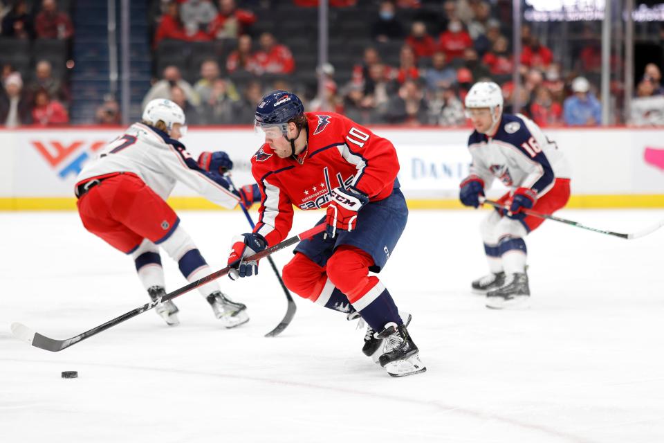 Feb 8, 2022; Washington, District of Columbia, USA; Washington Capitals right wing Daniel Sprong (10) skates with the puck past Columbus Blue Jackets defenseman Adam Boqvist (27) during the first period at Capital One Arena. Mandatory Credit: Geoff Burke-USA TODAY Sports