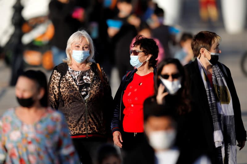 Women wear face masks amid the coronavirus disease (COVID-19) crisis as they walk in Ashkelon