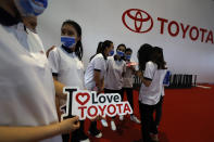 Promoters for Toyota prepare for duty during the Shanghai Auto Show in Shanghai on Monday, April 19, 2021. Automakers are looking to China, their biggest market by sales volume and the first major economy to rebound from the pandemic, to revive sales and reverse multibillion-dollar losses. (AP Photo/Ng Han Guan)