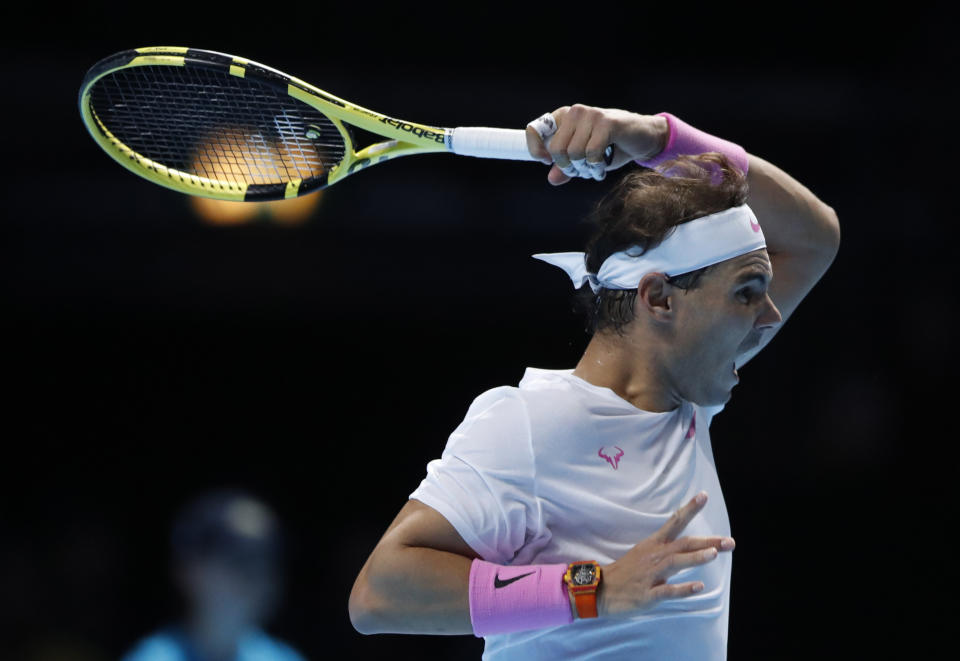 Spain's Rafael Nadal plays a return to Stefanos Tsitsipas of Greece during their ATP World Tours Finals singles tennis match at the O2 Arena in London, Friday, Nov. 15, 2019. (AP Photo/Alastair Grant)