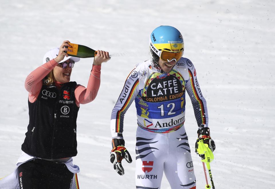 Germany's Felix Neureuther is sprayed with champagne at the end of a men's alpine ski World Cup slalom, in Soldeu, Andorra, Sunday, March 17, 2019. Neureuther announced his retirement at the end of the World Cup. (AP Photo/Alessandro Trovati)