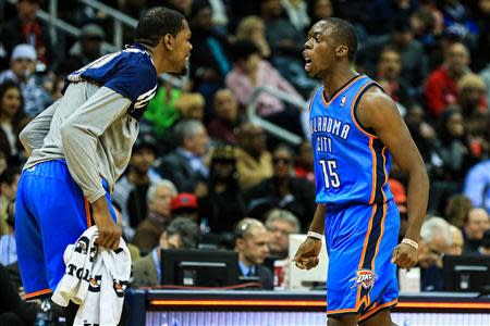 Oklahoma City Thunder point guard Reggie Jackson (15) celebrates with small forward Kevin Durant (left) after making a buzzer beater shot to end the third quarter against the Atlanta Hawks at Philips Arena. Mandatory Credit: Daniel Shirey-USA TODAY