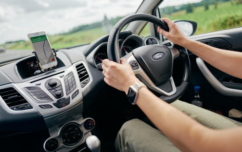 A simple wave or a thumbs up by a driver is a possible breach of having control of the vehicle and can rack up a £1000 fine (Getty Images)