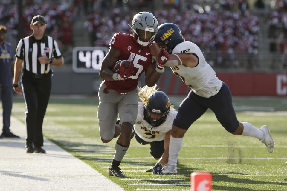 Washington State running back Djouvensky Schlenbaker (15) carries the ball while pressured by Northern Colorado defensive back Jordan Knapke, right, during the second half of an NCAA college football game, Saturday, Sept. 16, 2023, in Pullman, Wash. Washington State won 64-21. (AP Photo/Young Kwak)