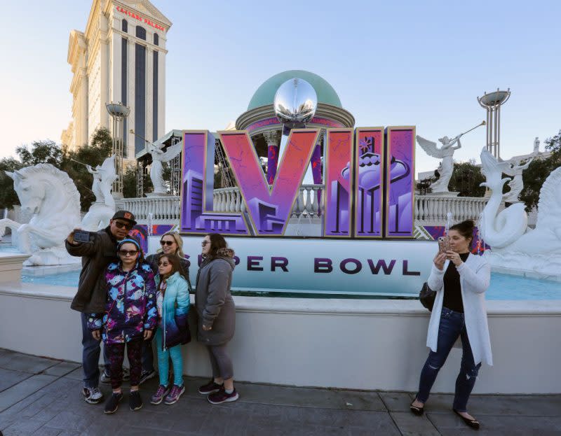 Visitors pose in front of a Super Bowl LVIII logo on the Las Vegas Strip in Nevada on Feb. 3, 2024. (Ethan Miller/Getty Images)