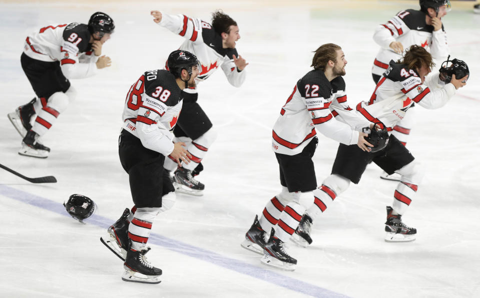 Canada's team players celebrate as they won the Ice Hockey World Championship final match between Finland and Canada at the Arena in Riga, Latvia, Sunday, June 6, 2021. (AP Photo/Sergei Grits)