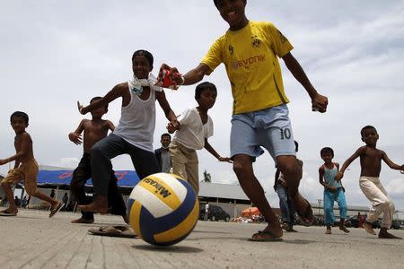 Rohingya children, who arrived in Indonesia by boat, play soccer outside a shelter in Kuala Langsa, in Indonesia's Aceh Province, May 17, 2015. REUTERS/Roni Bintang