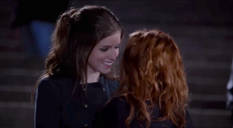 Anna Kendrick and Brittany Snow have a close conversation on steps in an intimate scene