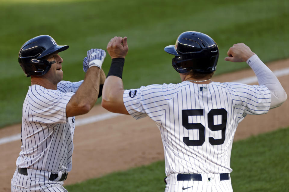 New York Yankees' Brett Gardner is congratulated by Luke Voit (59) after hitting a two-run home run during the first inning of the first baseball game of a doubleheader against the Baltimore Orioles, Friday, Sept. 11, 2020, in New York. (AP Photo/Adam Hunger)