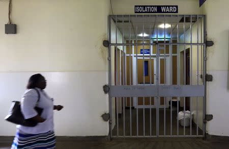 A woman walks past an isolation ward (R) set aside for Ebola related cases at the Kenyatta National Hospital (KNH) in the capital Nairobi August 19, 2014. REUTERS/Noor Khamis