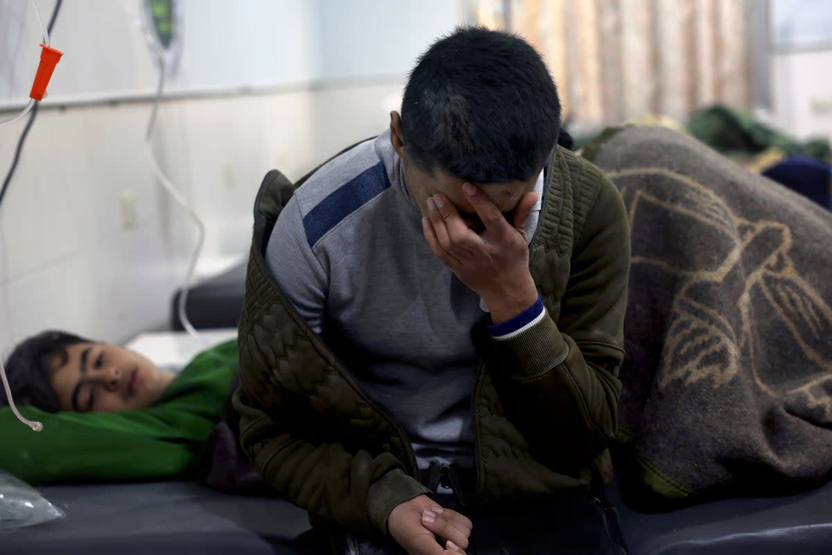 Earthquake victims receive treatment at the al-Rahma Hospital in the town of Darkush, Idlib province (AP)