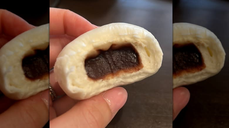 person holding red bean bao