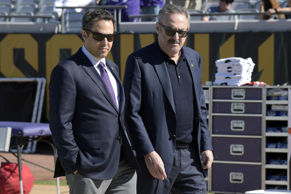 FILE - In this Dec. 11, 2016, file photo, Minnesota Vikings owners Mark Wilf, left, and Zygi Wilf watch warmups from the sideline before an NFL football game against the Jacksonville Jaguars in Jacksonville, Fla. The owners of the Minnesota Vikings have finalized the acquisition of Orlando City, giving the Wilf family control of the MLS franchise. (AP Photo/Phelan M. Ebenhack, File)