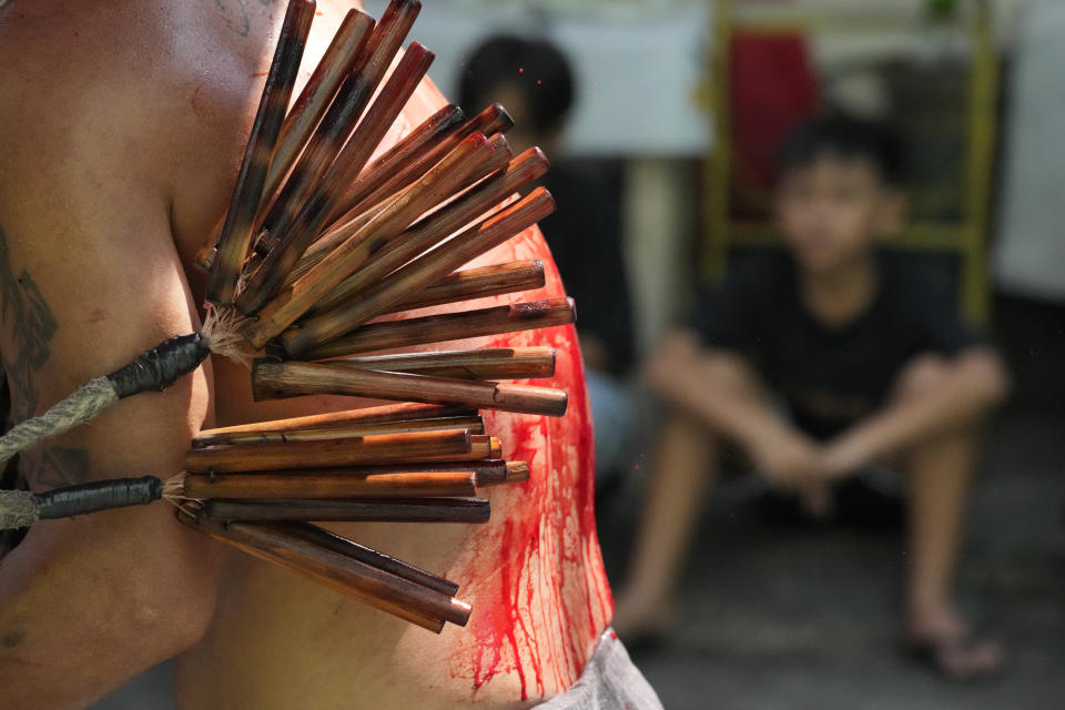 A hooded Filipino penitent flagellates himself as part of Holy Week rituals to atone for sins or fulfill vows for an answered prayer in metropolitan Manila, Philippines on Maundy Thursday, March 28, 2024. The bizarre lenten ritual is frowned upon by the church in this predominantly Roman Catholic country. (AP Photo/Aaron Favila)