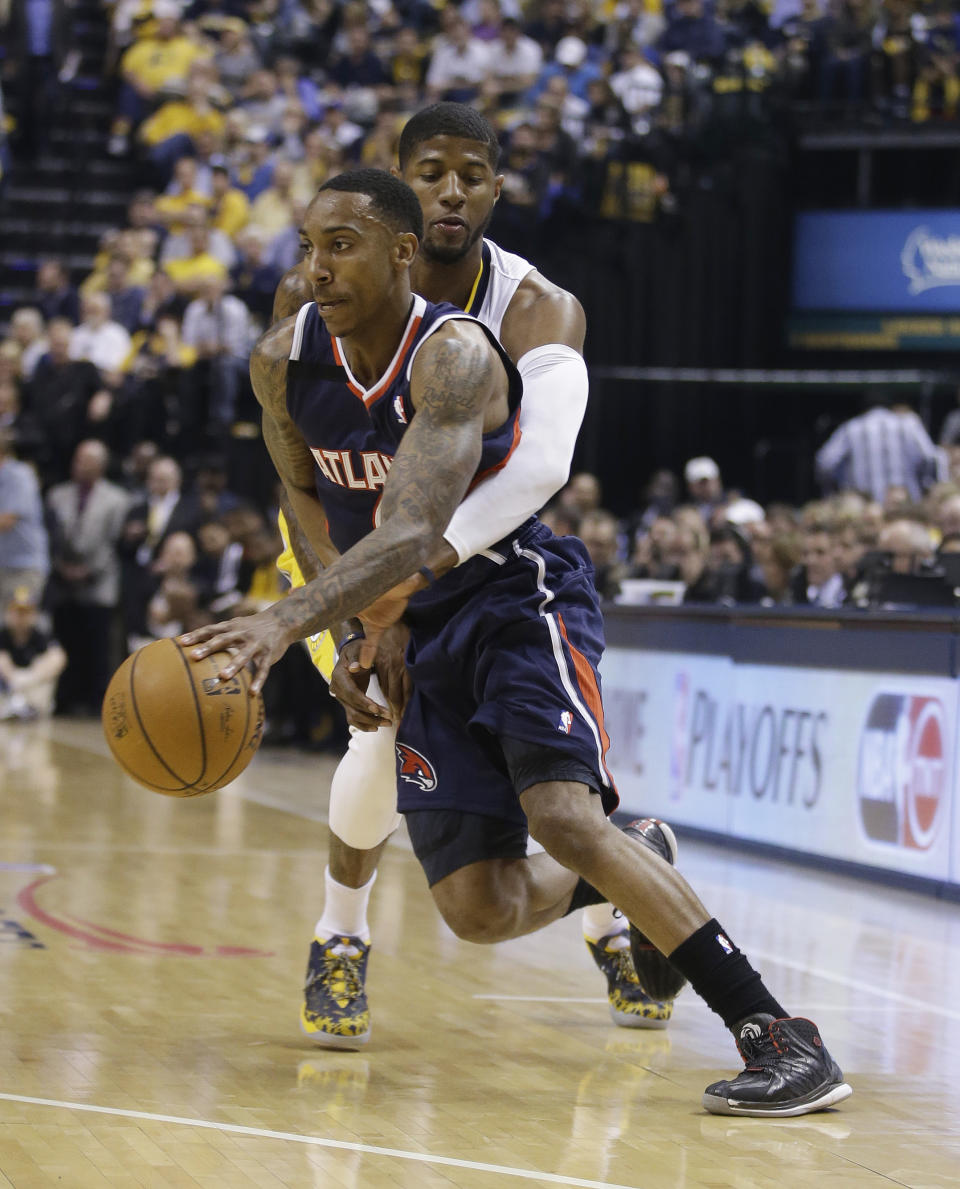 Atlanta Hawks' Jeff Teague is defended by Indiana Pacers' Paul George during the first half in Game 2 of an opening-round NBA basketball playoff series Tuesday, April 22, 2014, in Indianapolis. (AP Photo/Darron Cummings)