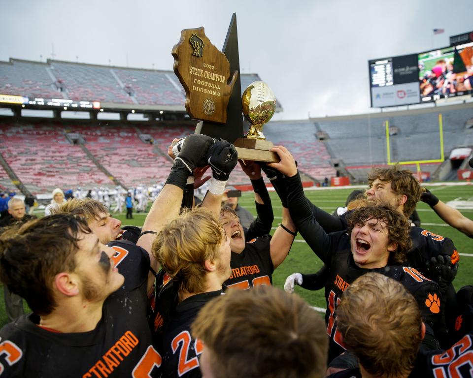 Stratford players hoist the state championship trophy after beating Mondovi during the WIAA Division 6 state championship game Thursday at Camp Randall Stadium in Madison.