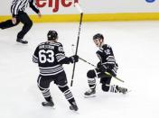 Feb 18, 2019; Chicago, IL, USA; Chicago Blackhawks left wing Alex DeBrincat (12) reacts next to defenseman Carl Dahlstrom (63) after scoring against the Ottawa Senators during the second period at United Center. Mandatory Credit: Kamil Krzaczynski-USA TODAY Sports