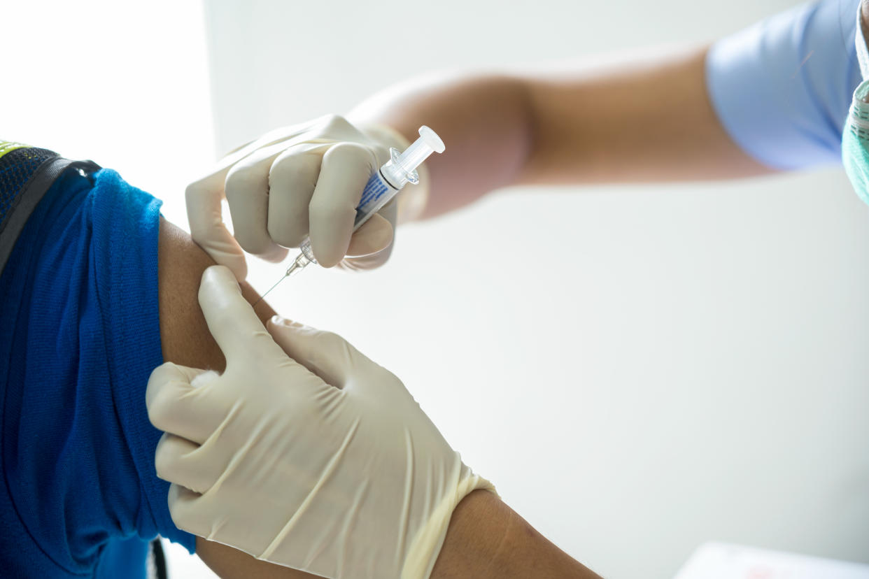 A doctor is giving a flu vaccine for illness prevention.