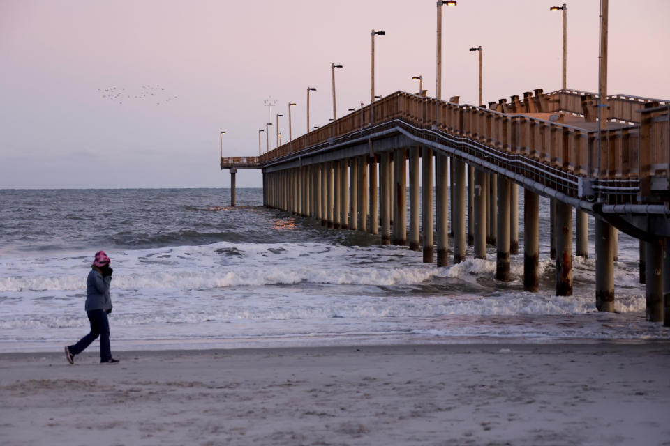 A person walks near the Springmaid Pier Saturday, Feb. 4, 2023, in Myrtle Beach, S.C. Earlier in the day, a Chinese balloon was shot down in the area. (AP Photo/Chris Seward)