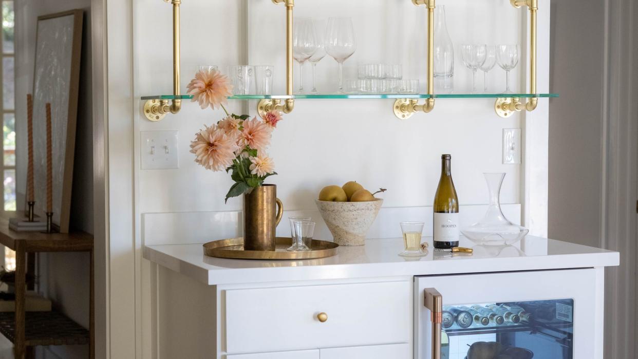 a white cabinet with glasses and bottles