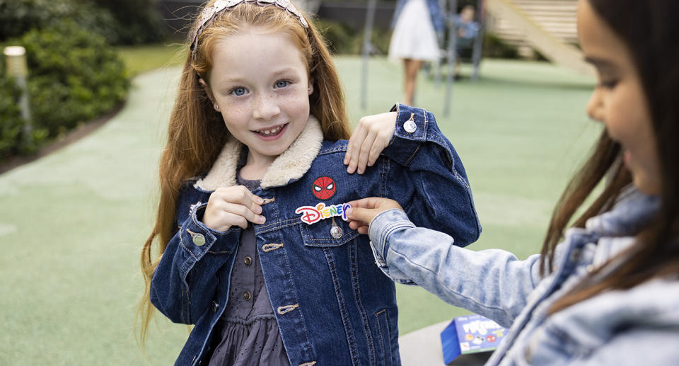 A girl wears a Woolworths Fix-ems patch on her denim jacket.