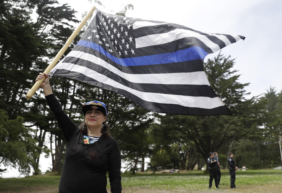 <p>Laura Zulema waves a flag in support of the group Patriot Prayer during a news conference in Pacifica, Calif, Saturday, Aug. 26, 2017. (Photo: Marcio Jose Sanchez/AP) </p>