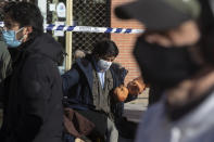 A stall-holder organises his display in the Rastro flea market in Madrid, Spain, Sunday, Nov. 22, 2020. Madrid's ancient and emblematic Rastro flea market reopened Sunday after a contentious eight-month closure because of the COVID-19 pandemic that has walloped the Spanish capital. (AP Photo/Paul White)