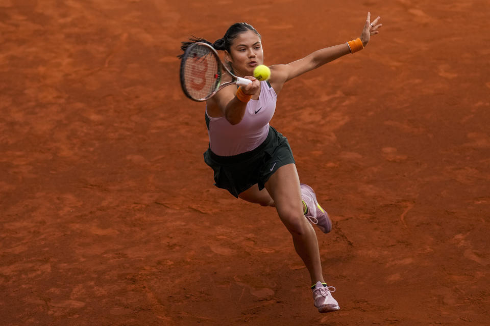 Britain's Emma Raducanu returns the ball against Marta Kostyuk of Ukraine during their match at the Mutua Madrid Open tennis tournament in Madrid, Spain, Sunday, May 1, 2022. (AP Photo/Manu Fernandez)