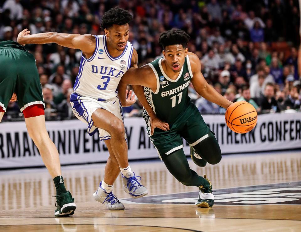 Michigan State guard A.J. Hoggard (11) dribbles against Duke guard Jeremy Roach (3) during the first half of the second round of the NCAA tournament at the Bon Secours Wellness Arena in Greenville, S.C..