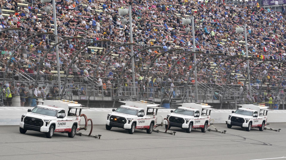 Trucks use air dryers after rain during a NASCAR Cup Series auto race at Michigan International Speedway in Brooklyn, Mich., Sunday, Aug. 6, 2023. (AP Photo/Paul Sancya)