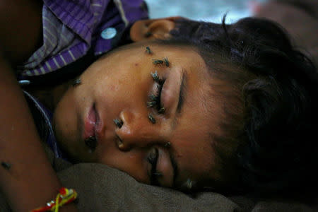 A child sleeps on the floor at the entrance to the Intensive care unit in the Baba Raghav Das hospital in Gorakhpur district, India August 13, 2017. REUTERS/Cathal McNaughton