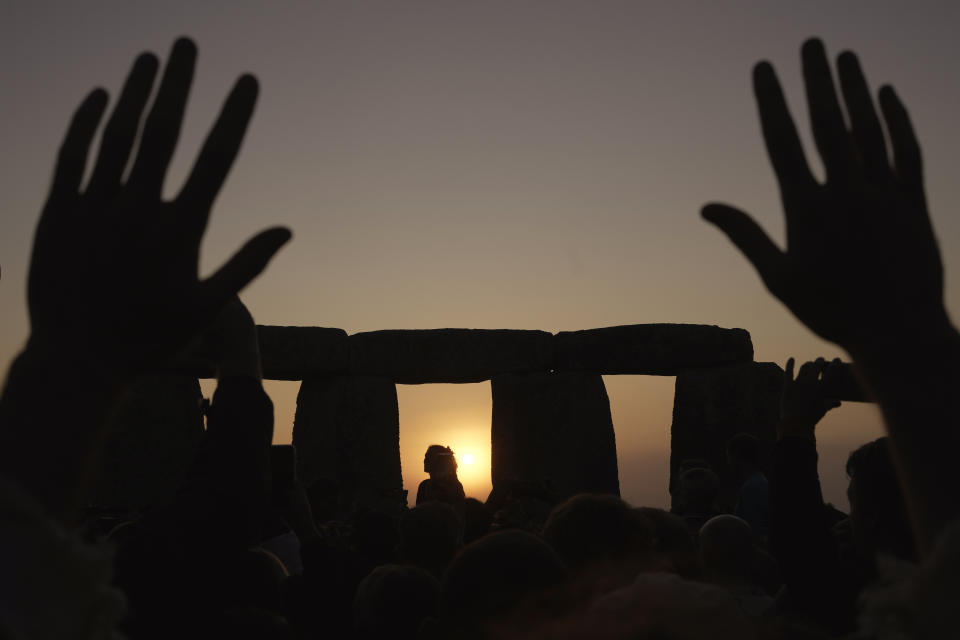 Revelers gather at the ancient stone circle Stonehenge to celebrate the Summer Solstice, the longest day of the year, near Salisbury, England, Wednesday, June 21, 2023. (AP Photo/Kin Cheung)