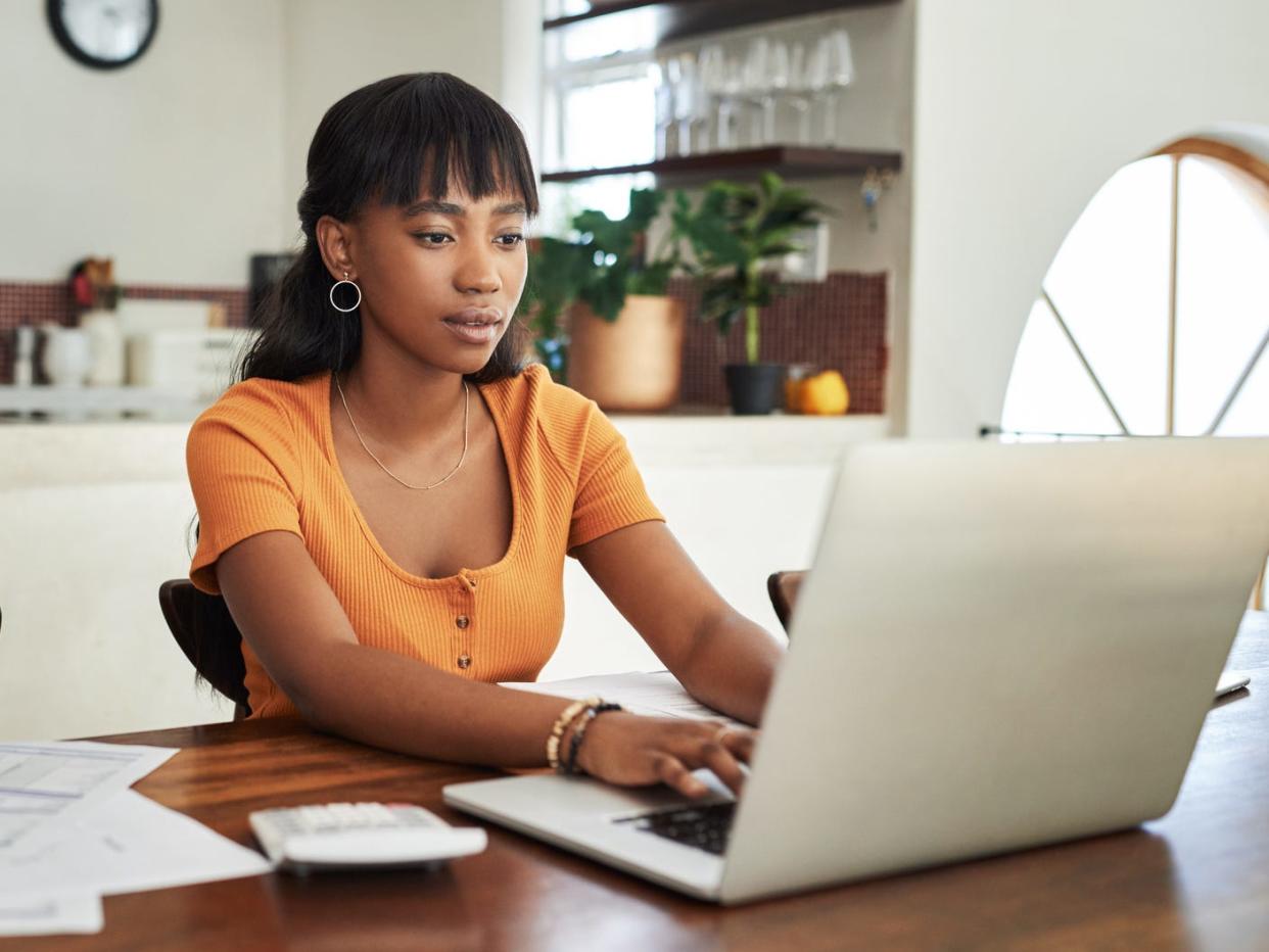 woman working on laptop in kitchen