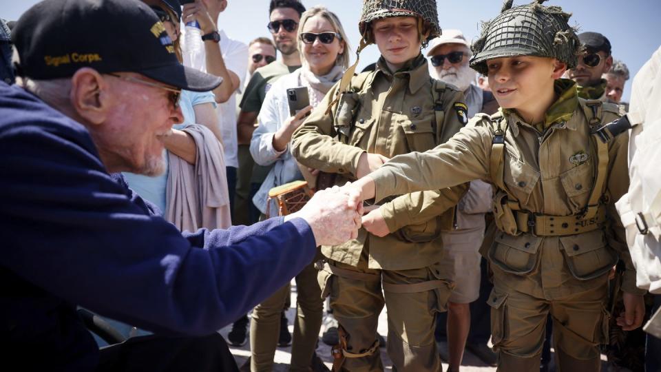 A U.S. veteran shakes hands with a World War II enthusiasts during a gathering in preparation of the 79th D-Day anniversary in Sainte-Mere-Eglise, Normandy, France, Sunday, June 4, 2023. (Thomas Padilla/AP)