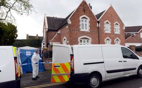 Police officers outside the Wilkinson family home in Stourbridge - Credit: Joe Giddens/PA