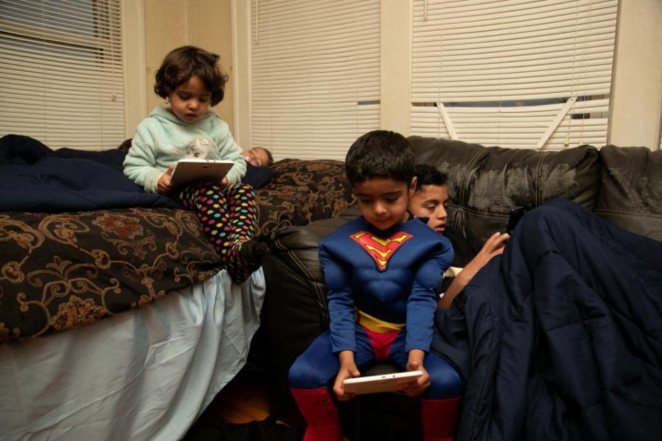 Sanaullah Khan Zadran dressed up as Superman, with siblings Zahra and Samiullah Khan (Reuters)