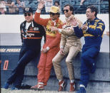 FILE - Indy 500 champs (from left) A.J. Foyt, Rick Mears, Danny Sullivan and Al Unser joke with the crowd as they stand along the pit wall at the Indianapolis Motor Speedway on Saturday, May 21, 1988. Foyt and Unser have each won the 500 four times, Mears have won twice, and Sullvian one. Mears, Sullvian and Unser will start the start from the race from the front row; Foyt has not yet qualified. (AP Photo, File)