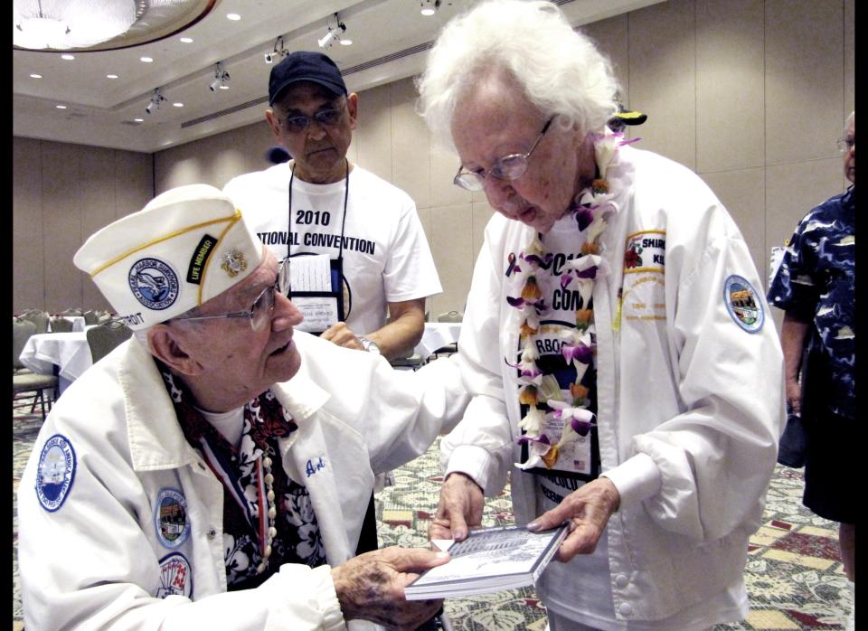 Pearl Harbor Suvivors Association President Art Herriford, left, is seen talking to his wife Shirley at the group's convention in Honolulu on Monday, Dec. 6, 2010. The association, which met in Waikiki a day before the anniversary, decided Monday not to disband and will continue for at least a while longer. 