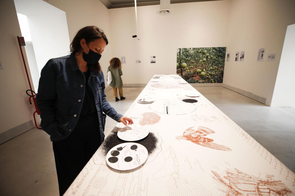 Malkit Shoshan, curator of the installation "Border Ecologies And The Gaza Strip" shows a detail of the installation during an interview with the Associated Press at a press preview of the exhibition "How will we live together?", at the Biennale International Architecture, in Venice, Italy, Wednesday, May 19, 2021. The 17th International Architecture Exhibition opens Saturday after a one-year pandemic delay, during which time architecture has emerged as one of the key disciplines in the global coronavirus response. (AP Photo/Alessandra Tarantino)