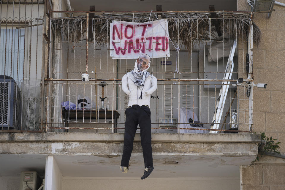 An effigy of Hamas leader Yehya Sinwar hangs off the balcony of an apartment under the sign "Not Wanted" in Jerusalem on Thursday, March 28, 2024. Israel says Sinwar is the mastermind of Hamas' deadly cross-border attack on Oct. 7 and says he remains in hiding in Gaza. (AP Photo/Ohad Zwigenberg)