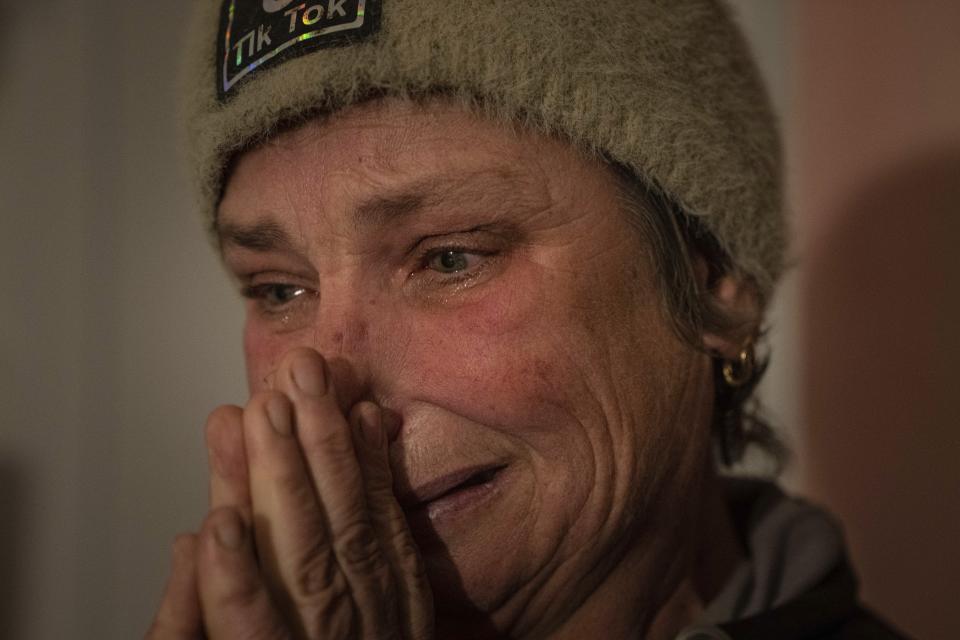 Maryna Semeniuk cries at her house in Vysoke village, Kherson region, Ukraine, Saturday, Dec. 3, 2022. Semeniuk's husband Mykola was injured by Russian soldiers in November and forcibly moved to Crimea, as well two of her sons were captured by Russian forces in July. (AP Photo/Evgeniy Maloletka)