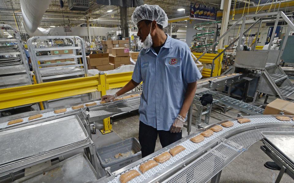 Jameel Coleman, 27, manages a production line of cherry pies at JTM Foods in Erie on Jan. 12. The company, which willl participate in a manufacturing job fair on Thursday, has more than 40 open positions.