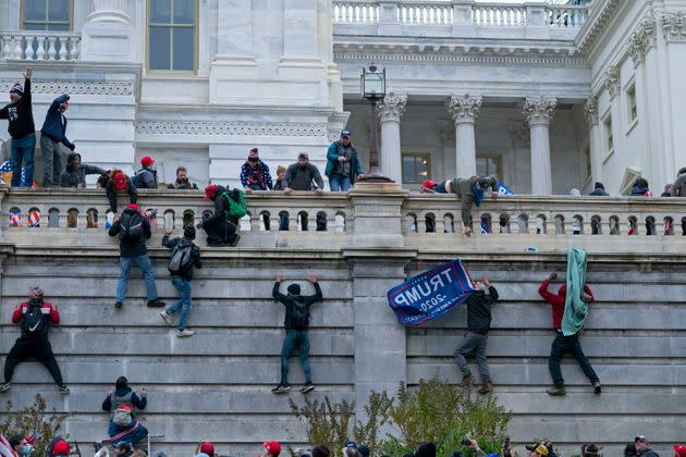 Rioters climb the west wall of the the U.S. Capitol in Washington during the Jan. 6 attack. (Photo: via Associated Press)