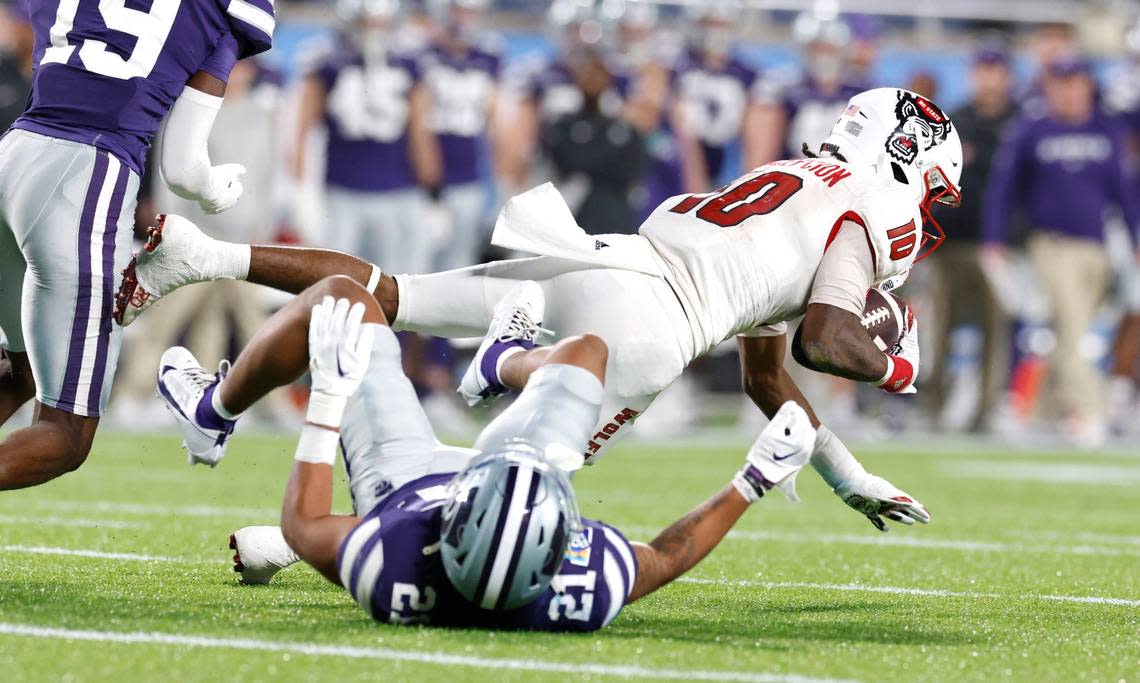 N.C. State wide receiver KC Concepcion (10) makes the reception while defended by Kansas State safety Marques Sigle (21) during the first half of N.C. State’s game against Kansas State in the Pop-Tarts Bowl at Camping World Stadium in Orlando, Fla., Thursday, Dec. 28, 2023. Ethan Hyman/ehyman@newsobserver.com
