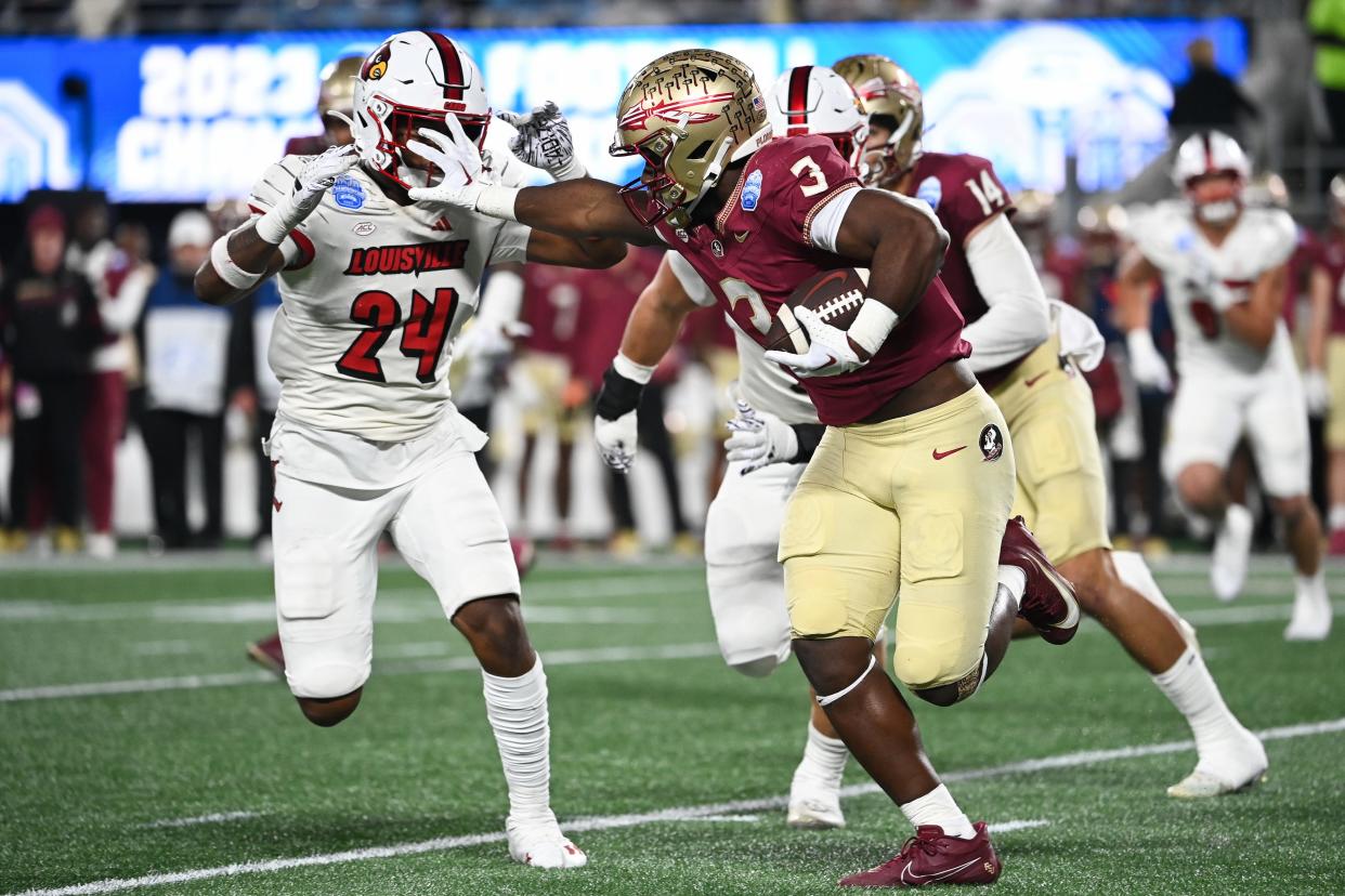 Dec 2, 2023; Charlotte, NC, USA; Florida State Seminoles running back Trey Benson (3) fends off Louisville Cardinals linebacker Jaylin Alderman (24) in the third quarter at Bank of America Stadium. Mandatory Credit: Bob Donnan-USA TODAY Sports